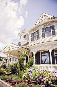 a white house with flowers in front of it at Castle Hill Inn in Newport