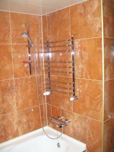 a bathroom with a shower with a tub at atHome in Sumy