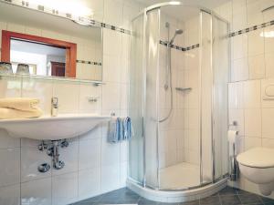 a bathroom with a sink and a shower at Pension Apartment Erna in Resia
