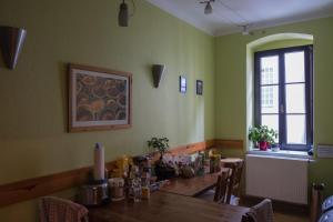 a dining room with a wooden table and a window at Hostel Louise 20 in Dresden