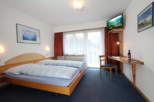 Postel nebo postele na pokoji v ubytování Hotel Garni Domino