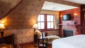 a hotel room with a bed and a fireplace at Castle Hill Inn in Newport