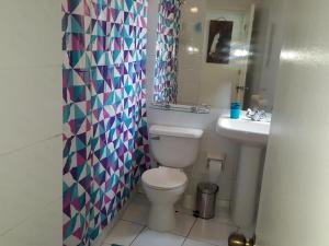 a bathroom with a toilet and a sink at Condominio Bahia Pelicanos - Horcon in Horcón +22 photos