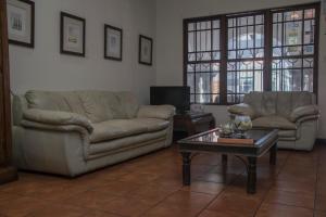 a living room with two couches and a coffee table at Hotel Colonial in San José