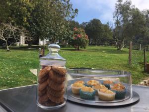 a jar of cupcakes and a plate of muffins at A Casa de Lelo in Ponteceso