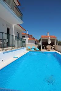 a large swimming pool in a villa with a house at Olive View in Vila Nova da Barquinha