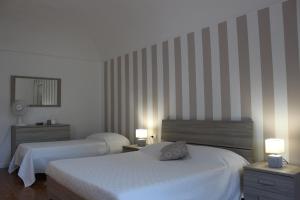 Łóżko lub łóżka w pokoju w obiekcie Villa Goria