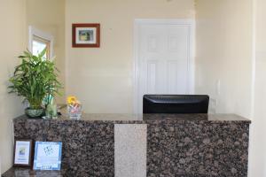 a room with a counter with a black chair at Beachway Inn in Arroyo Grande