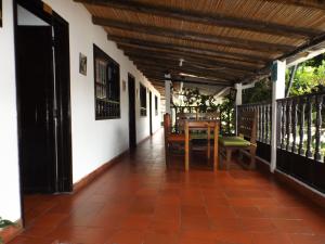 a porch of a house with a table and chairs at La Casona Nuñez in Iza