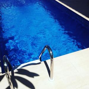 a swimming pool with a pair of sunglasses next to it at Blanc Residence in Pipa