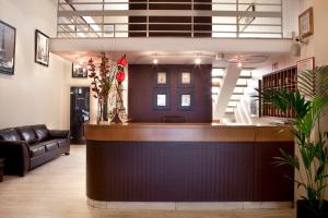 a lobby with a bar with a couch and stairs at Cit'Hotel Criden in Tours