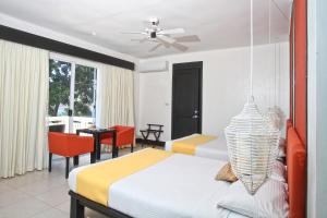 a bedroom with a bed and a table and chairs at Club Punta Fuego in Nasugbu