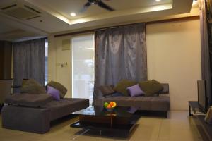 a living room with two couches and a television at 67 First Island in Bayan Lepas