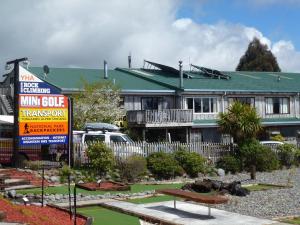 a inn with a sign in front of a building at National Park Backpackers in National Park