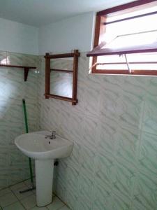 a bathroom with a sink and a window at Dilip's House in Tangalle