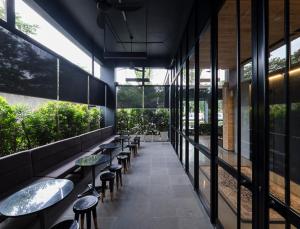 a corridor of a restaurant with tables and stools at Park 5 Cilandak in Jakarta