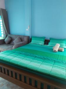 a bedroom with a bed and a couch at Sansook Chaolao in Chao Lao Beach