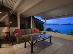 a living room with a couch and a table at Boujis Boutique Resort in Chaweng Noi Beach