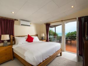 a bedroom with a large bed and a balcony at Boujis Boutique Resort in Chaweng Noi Beach