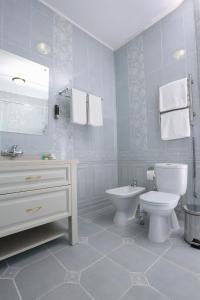 a bathroom with a toilet and a sink at Hotel Bahetle in Ekibastuz +26 photos
