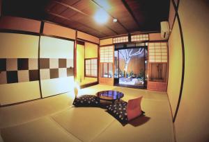 a living room with a couch and a table at Guesthouse Kioto in Kyoto