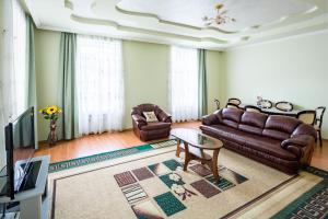 a living room with a couch and a table at Alfa Apartments Rynok Square 30 in Lviv
