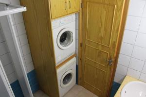 a washer and dryer in a small bathroom at Kaparris Apartment in Paralimni