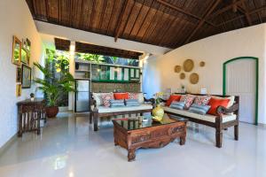 a living room with couches and a coffee table at Singgah Villas Seminyak in Seminyak