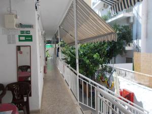 a hallway of a building with awnings and plants at Karampela Rooms in Loutra Edipsou