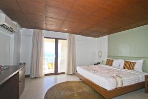 a bedroom with a bed and a large window at Club Punta Fuego in Nasugbu +60 photos