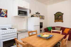 a kitchen and living room with a table and a couch at Ningana Heritage Houses in Mudgee