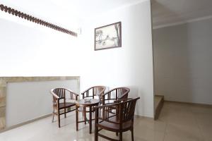 a dining room with a table and chairs at RedDoorz Plus near Adisucipto Airport 2 in Yogyakarta