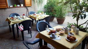 two tables with food on them on a patio at B&B ENSILEVA BEACH in Porto Garibaldi