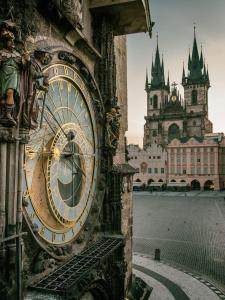 a clock on the side of a building at Pension Karlova in Prague