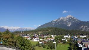 a village in the mountains with mountains in the background at Ferienhaus Heidi in Piller