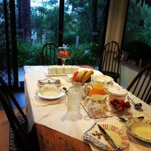 a table that has some food on it at Whispering Pines Bed and Breakfast in Collie