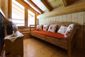 a room with a bed in a cabin with windows at Agritur Manoncin in Daone