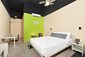 
a bed room with a white bedspread and a white wall at Abraham Hostel Tel Aviv in Tel Aviv
