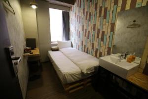 Postel nebo postele na pokoji v ubytování NYS Loft Hotel