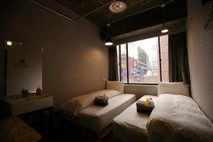 Postel nebo postele na pokoji v ubytování NYS Loft Hotel