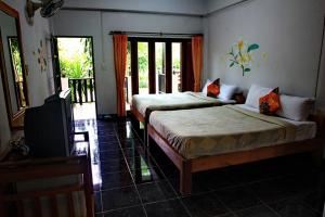 Postel nebo postele na pokoji v ubytování Baan Chanoknunt Resort Pai