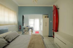a bedroom with a bed and a dining room at J Bay Dreaming in Jeffreys Bay