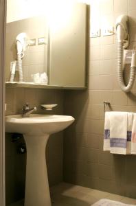 a bathroom with a sink and a mirror at Santuario di Oropa in Biella
