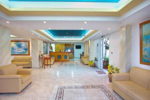 a lobby with couches and tables in a building at Pinelopi Apartments in Georgioupolis