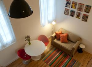 a small living room with a table and a couch at Coimbra Vintage Lofts Apartments in Coimbra