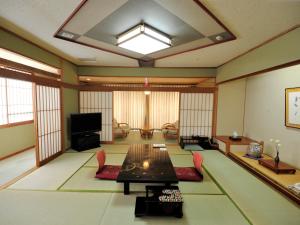 a large living room with a table and chairs at Nisshokan Shinkan Baishokaku in Nagasaki