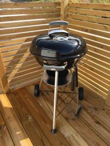 a grill sitting on top of a wooden deck at Guest Haush Ånneröd in Strömstad