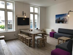 a living room with a table and a couch at Gästezimmer an der Elbphilharmonie contactless Check in in Hamburg