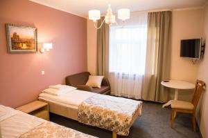 Postel nebo postele na pokoji v ubytování Ankur Hotell