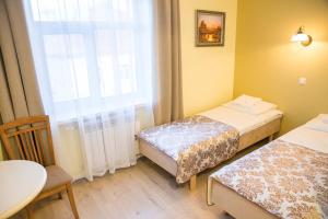 Postel nebo postele na pokoji v ubytování Ankur Hotell